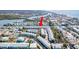 Aerial view of waterfront condos with boat docks, conveniently located near the bridge and waterfront amenities at 657 Garland Cir, Indian Rocks Beach, FL 33785