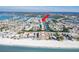 Breathtaking aerial view of a beachfront condo complex with boat docks and community pools in a coastal setting at 657 Garland Cir, Indian Rocks Beach, FL 33785