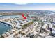 Aerial view of waterfront condos with boat docks, conveniently located near the bridge and waterfront amenities at 657 Garland Cir, Indian Rocks Beach, FL 33785