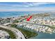 Scenic aerial view of a waterfront condo community, complete with boat docks and convenient road access at 657 Garland Cir, Indian Rocks Beach, FL 33785
