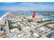 Expansive aerial shot of a waterfront condo community with boat docks, coastal proximity, and local roadways at 657 Garland Cir, Indian Rocks Beach, FL 33785