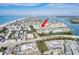 Picturesque aerial view of a waterfront condo community featuring boat docks, easy access to local roads, and a pool at 657 Garland Cir, Indian Rocks Beach, FL 33785