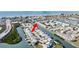 Attractive aerial view of a waterfront condo community featuring boat docks and surrounded by lush greenery and waterways at 657 Garland Cir, Indian Rocks Beach, FL 33785