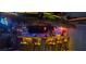 Custom-built bar with a thatched roof, neon lighting, and unique decor creates a fun and inviting atmosphere at 657 Garland Cir, Indian Rocks Beach, FL 33785