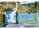 Overhead shot of pool and tennis court; features lounge chairs, a jacuzzi, and parking at 657 Garland Cir, Indian Rocks Beach, FL 33785