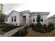 Charming single-story home featuring stone accents, well-maintained landscaping, and a paved walkway to the front door at 695 Allora Ave, Nokomis, FL 34275