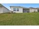 The backyard features a well-manicured lawn, side yards, and a view of a screened-in lanai at 11341 Hardwood Hammock Ln, Riverview, FL 33569