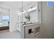 This bathroom features a large glass mirror, dual sinks, and a glass shower wall at 11341 Hardwood Hammock Ln, Riverview, FL 33569