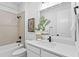 This bathroom features a bathtub and shower with neutral tiling and a modern vanity at 11341 Hardwood Hammock Ln, Riverview, FL 33569
