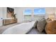This bedroom features a large bed with decorative pillows and a great water view from the two large windows at 11341 Hardwood Hammock Ln, Riverview, FL 33569