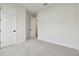 Spacious bedroom with neutral carpet and white trim, illuminated by natural light at 11341 Hardwood Hammock Ln, Riverview, FL 33569
