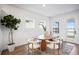 Bright dining area features modern decor, hardwood floors, and natural light at 11341 Hardwood Hammock Ln, Riverview, FL 33569
