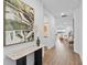 Bright hallway features contemporary art and a view into the open-concept living space at 11341 Hardwood Hammock Ln, Riverview, FL 33569