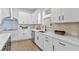 Modern kitchen features a stainless steel sink, sleek cabinets, and an updated backsplash at 11341 Hardwood Hammock Ln, Riverview, FL 33569