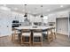 Kitchen featuring a large island with seating, modern lighting, and updated appliances at 11341 Hardwood Hammock Ln, Riverview, FL 33569