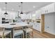 Bright, modern kitchen with a large island, stainless steel appliances, and sleek white cabinetry at 11341 Hardwood Hammock Ln, Riverview, FL 33569