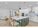 Open kitchen with a large island, pendant lighting, and modern finishes at 11341 Hardwood Hammock Ln, Riverview, FL 33569