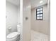 Neat bathroom with tiled shower and floor, modern toilet and neutral wall color at 13600 Egret Blvd # 204K, Clearwater, FL 33762