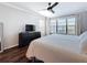 Bright bedroom featuring hardwood floors, a ceiling fan, and natural light from a large window at 13600 Egret Blvd # 204K, Clearwater, FL 33762