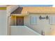 Close-up of the entry of a unit showing address number, lights, door, and window at 13600 Egret Blvd # 204K, Clearwater, FL 33762