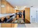 Features black appliances and granite countertops with a breakfast bar area at 13600 Egret Blvd # 204K, Clearwater, FL 33762