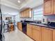 Shows the kitchen with natural wood cabinets, granite countertops and black appliances at 13600 Egret Blvd # 204K, Clearwater, FL 33762