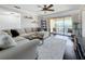 Shows a living room with hardwood floors, a sectional sofa, and a sliding glass door to the balcony at 13600 Egret Blvd # 204K, Clearwater, FL 33762