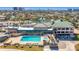 An aerial shot showing a community clubhouse, swimming pool, hot tub, seating, and manicured lawn at 13600 Egret Blvd # 204K, Clearwater, FL 33762