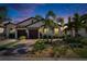 Charming home with a brick driveway, lush landscaping, and a two-car garage at 17014 Clear Cork Dr, Wimauma, FL 33598