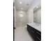 Sleek bathroom with marble shower, dark vanity and white countertop at 2081 Michigan Ne Ave, St Petersburg, FL 33703