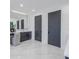 Bathroom featuring dual gray accent doors and a vanity with a lighted mirror at 2081 Michigan Ne Ave, St Petersburg, FL 33703