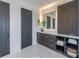 Bathroom featuring storage shelves with towels, gray accent doors and a lighted mirror at 2081 Michigan Ne Ave, St Petersburg, FL 33703