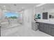 Beautiful bathroom with soaking tub, large glass shower, and vanity with a lighted mirror at 2081 Michigan Ne Ave, St Petersburg, FL 33703