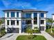 Striking two-story modern home with a manicured lawn, stone accents, and a beautiful architectural design at 2081 Michigan Ne Ave, St Petersburg, FL 33703