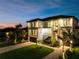 Stunning exterior view of a modern, multi-story waterfront home with beautiful landscaping and driveway at 2081 Michigan Ne Ave, St Petersburg, FL 33703