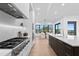 Modern kitchen with stainless steel appliances, gas range, and island with marble countertops at 2081 Michigan Ne Ave, St Petersburg, FL 33703
