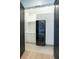 Bright laundry room features a stacked washer/dryer and built-in storage cabinets at 2081 Michigan Ne Ave, St Petersburg, FL 33703