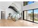 Bright living room featuring hardwood floors, modern staircase, and views of the water at 2081 Michigan Ne Ave, St Petersburg, FL 33703