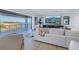 Open living room with sofa, large sliding doors, and beautiful water views at 2081 Michigan Ne Ave, St Petersburg, FL 33703