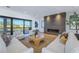 Spacious living room with fireplace, comfortable seating, and access to a balcony overlooking the water at 2081 Michigan Ne Ave, St Petersburg, FL 33703