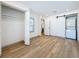 A bedroom featuring closet, laundry area with stacked washer and dryer, and light-colored wood floors at 2427 10Th S Ave, St Petersburg, FL 33712