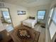 Cozy bedroom with a decorative rug, comfortable bed, and natural light from the windows at 2427 10Th S Ave, St Petersburg, FL 33712