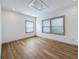 A bedroom featuring two windows and light-colored wood floors at 2427 10Th S Ave, St Petersburg, FL 33712