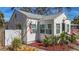 Charming single-story home featuring a freshly painted white exterior and neat landscaping with an American flag at 2427 10Th S Ave, St Petersburg, FL 33712