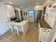 Well-lit kitchen features a modern island with seating, stainless steel appliances, and ample counter space at 2427 10Th S Ave, St Petersburg, FL 33712