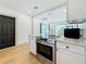 A modern kitchen with stainless steel appliances and an island with barstool seating overlooks the dining area at 2427 10Th S Ave, St Petersburg, FL 33712