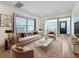 A living room with an open floor plan boasts a decorative fireplace, large windows, and modern decor at 2427 10Th S Ave, St Petersburg, FL 33712