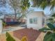A side exterior view of a newly renovated home featuring a well-maintained yard and fresh paint at 2427 10Th S Ave, St Petersburg, FL 33712