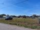 Wide view of a large fenced property, showcasing space and potential at 2601 11Th Se Ave, Ruskin, FL 33570