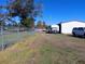 Fenced property showcasing a mix of residential and storage buildings at 2601 11Th Se Ave, Ruskin, FL 33570